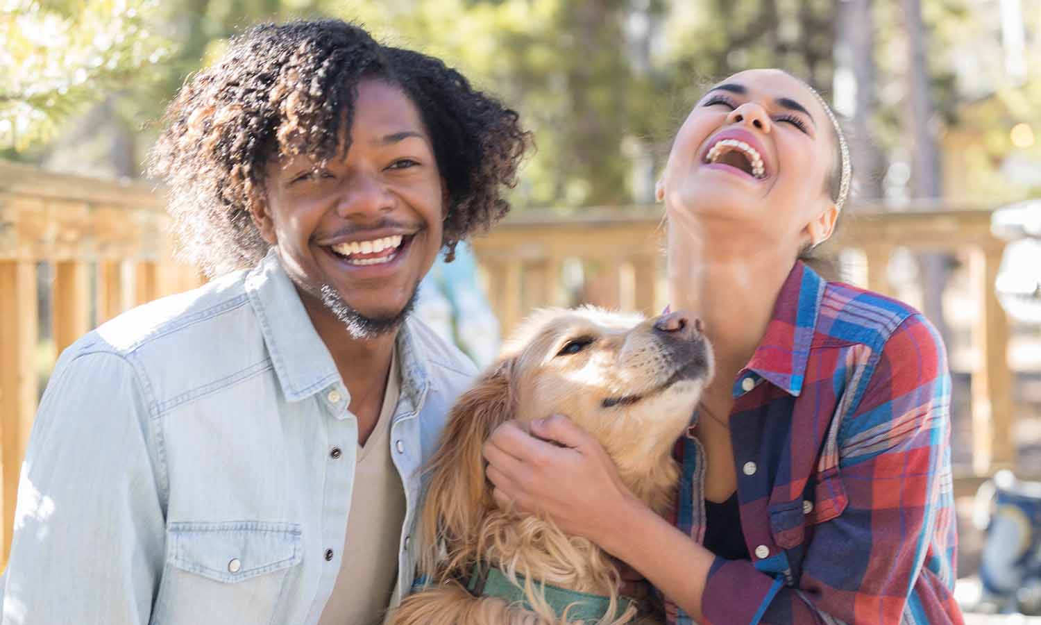 Two people holding their dog